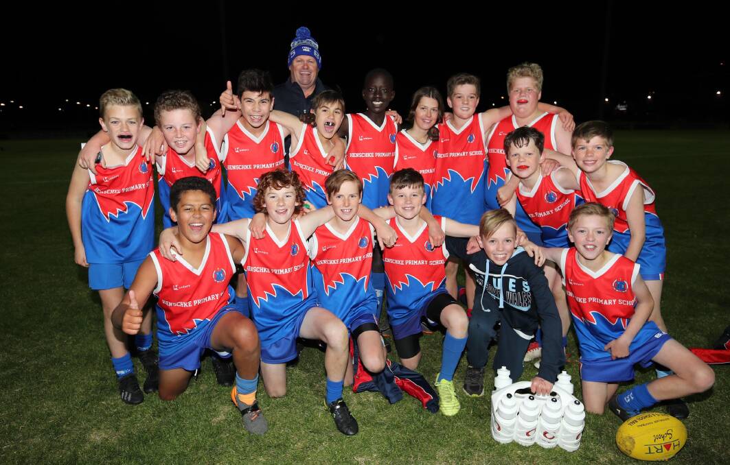 WINNERS ARE GRINNERS: Henschke celebrate their Paul Kelly Cup final win over Mater Dei Primary School at Robertson Oval last night. Picture: Les Smith
