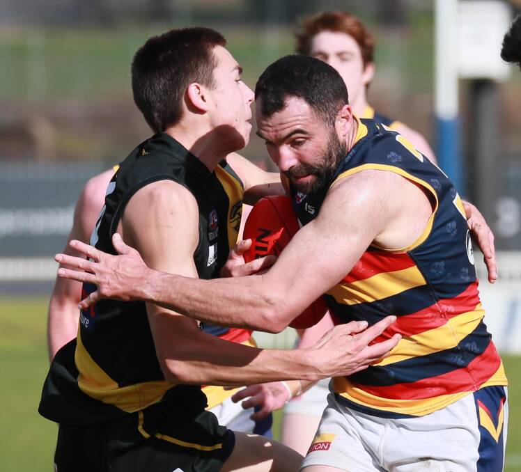 BACK FOR CROWS: Leeton-Whitton stalwart tries to evade a Wagga Tigers tackler last season. Picture: Les Smith