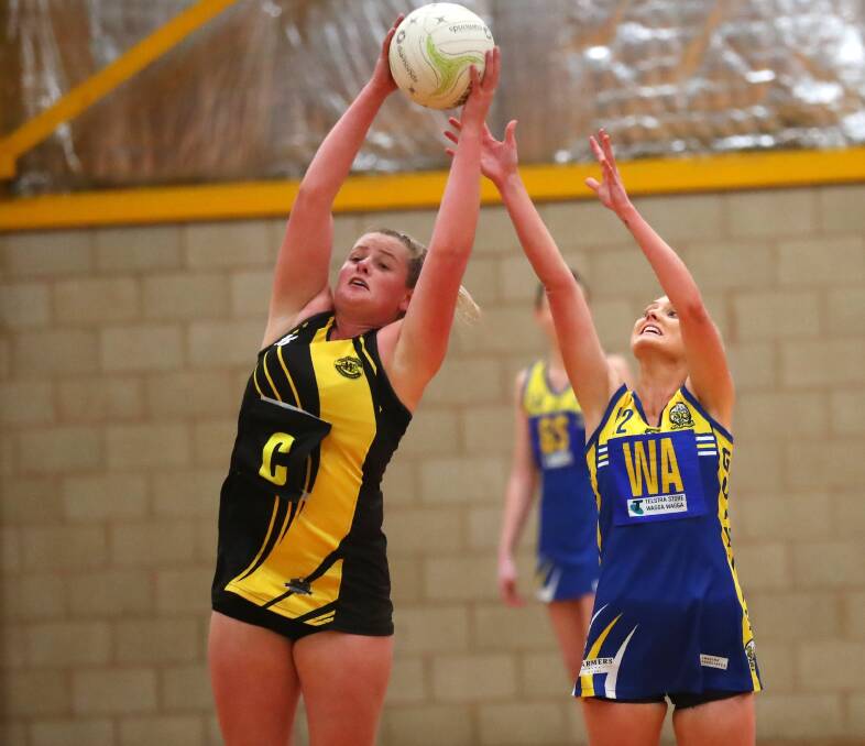 INTENSE: Wagga Tigers' Olivia Tilyard and MCUE's Mikaela Cole. Picture: Emma Hillier