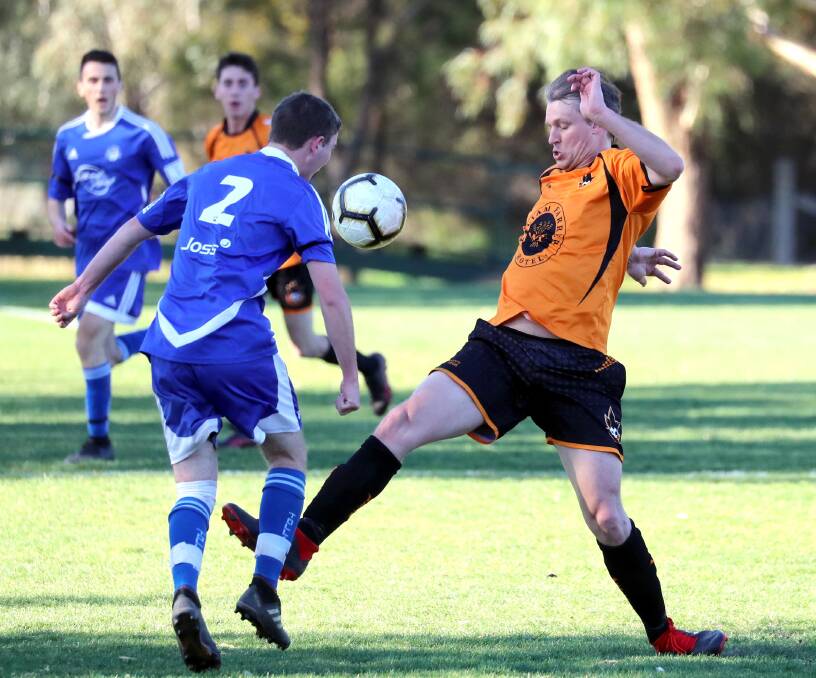 TENSE CLASH: Tolland's Adrian Jones and Wagga United's Adrian Merrigan lock horns during Sunday's 1-all draw at Rawlings Park. Picture: Les Smith