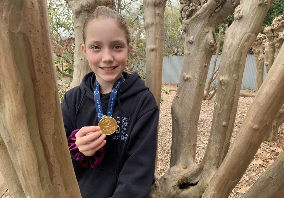 GOLD RUSH: Wagga Cycling Club's Carrington Oke with the gold medal she received for winning the junior state criterium championship in Sydney on the weekend. Picture: Jon Tuxworth