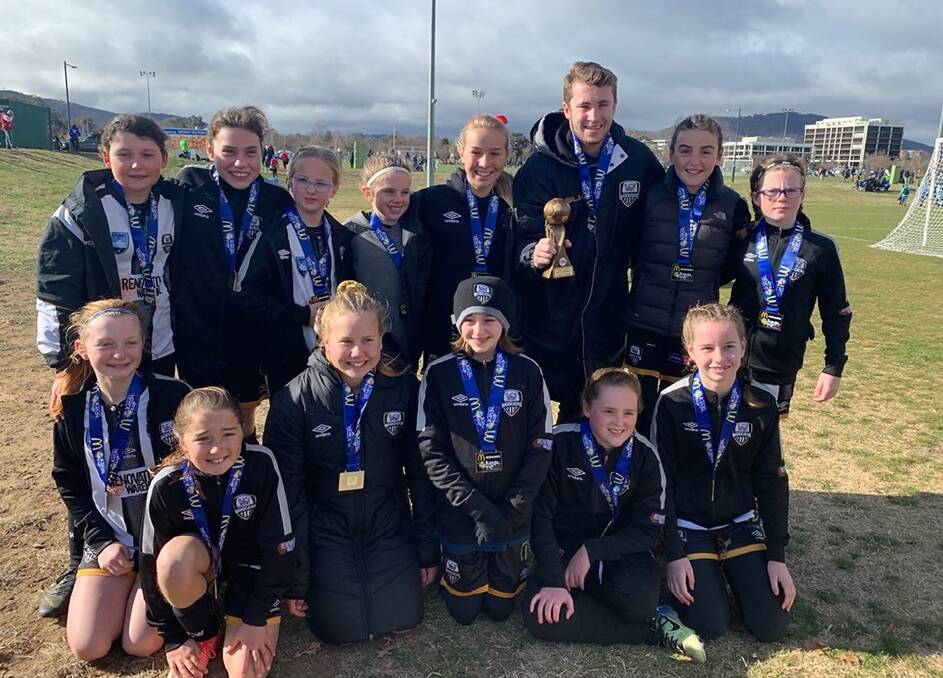 CHAMPIONS: The Wagga City Wanderers under-12 girls celebrate winning their Kanga Cup grand final. 