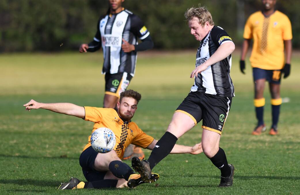 BREAKTHROUGH WIN: Bridabella's Charlie Williams and Wagga City's Duncan Cameron compete for the ball on Saturday. 