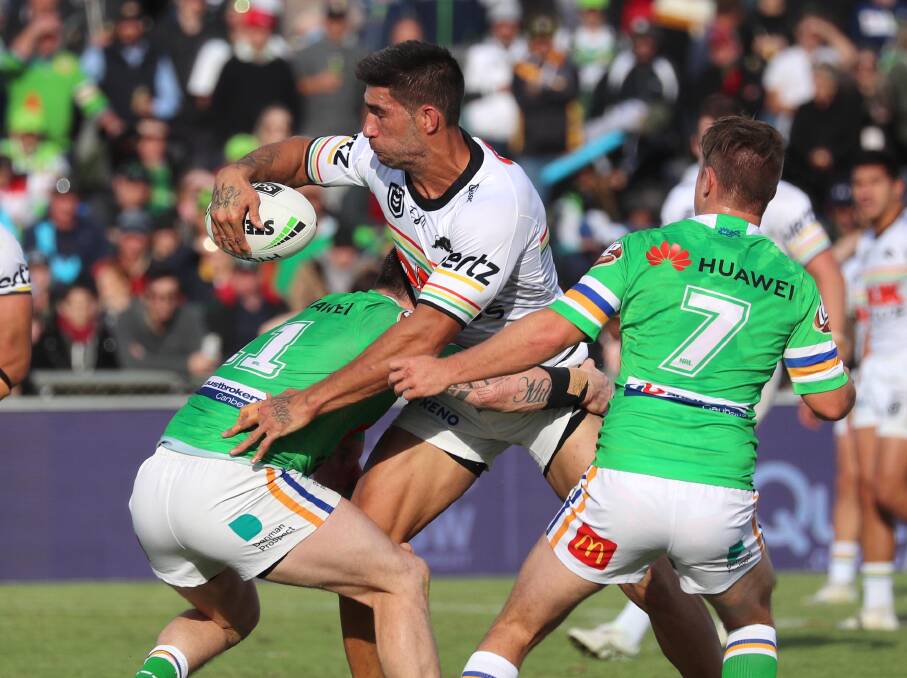 TOUGH DEFENCE: Penrith captain James Tamou is tackled by the Raiders. 