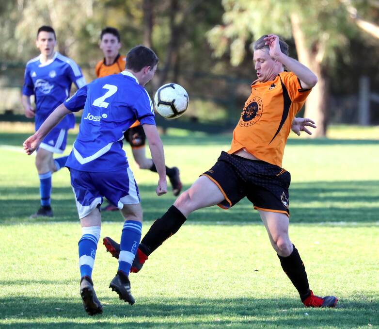 BACK SOON: Tolland's Adrian Jones and Wagga United's Adrian Merrigan contest the ball during a game last year. Picture: Les Smith

