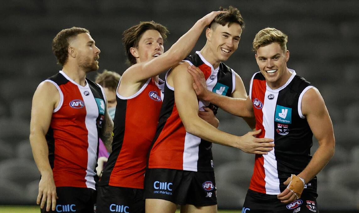 BIG MOMENT: Leeton's Cooper Sharman (third from left) is congratulated by St Kilda teammates after kicking his first AFL goal against Carlton on Friday. Picture: Getty Images