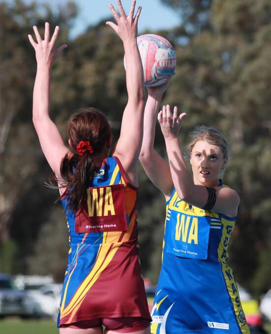 GOOD WIN: MCUE's Mikaela Cole tries to pass over GGGM's Chloe Hamblin at Mangoplah Sportsground on Saturday. Picture: Les Smith