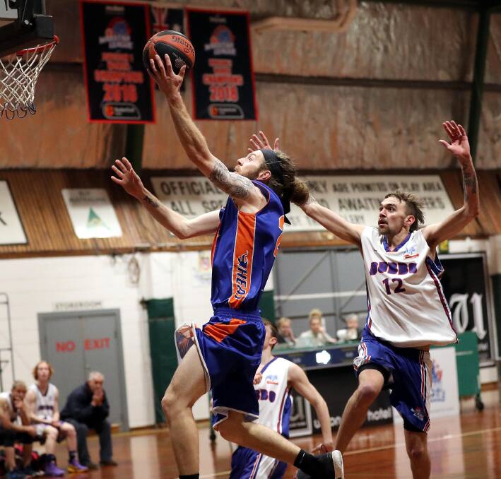STRONG FINISH: Wagga Heat's Dom Tye drives to the basket ahead of Dubbo's NIck Conte during their 91-82 win in their final game of the year on Saturday: Picture: Les Smith