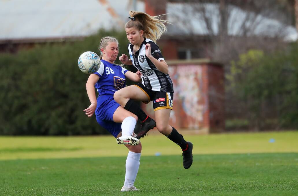 FINALS BOUND: Canberra Olympic's Zoe Neussand Wagga City's Beth Huxley compete for the ball during the Wanderers' 7-0 final round win in the under-17s. Picture: Emma Hillier