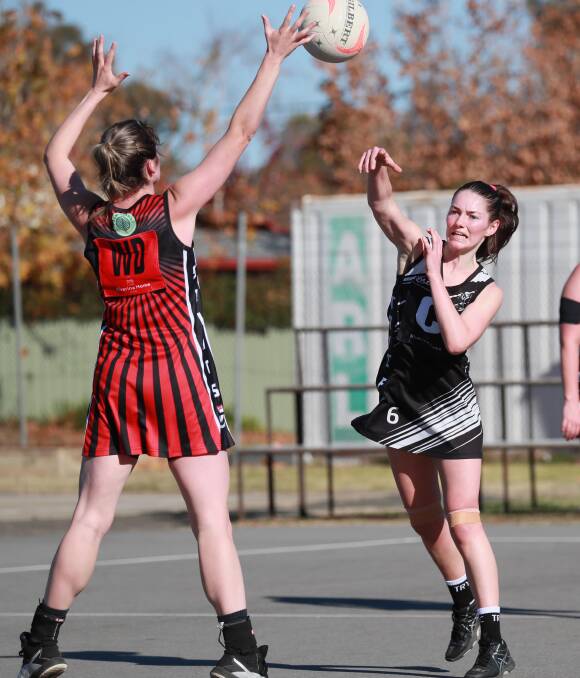 PASSING GAME: The Rock-Yerong Creek's Demi Taylor looks to pass over North Wagga's Katelyn Scroope. Picture: Les Smith