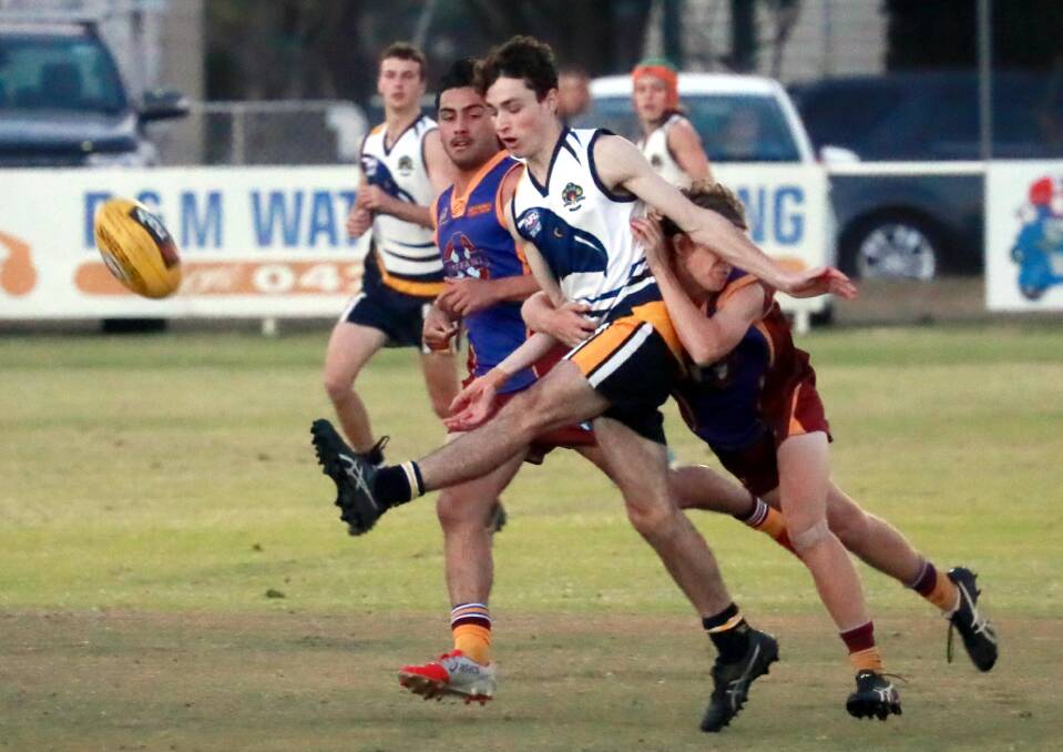 TOUGH SLOG: Kooringal High's Liam Davies gets a kick away despite a tackle from Mater Dei's Jake Hockley at McPherson Oval on Wednesday. Picture: Les Smith