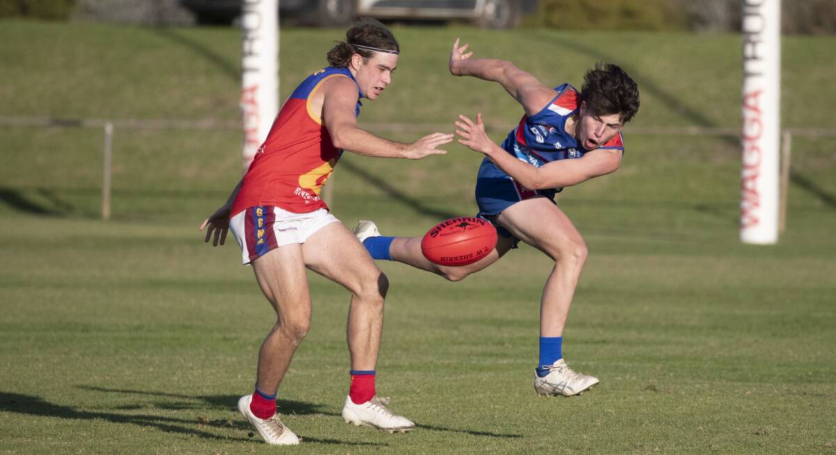 UNBEATEN: GGGM's Matthew Hamblin tussles with Turvey Park's Luke Mazzocchi during the Lions' win on Saturday. Picture: Madeline Begley