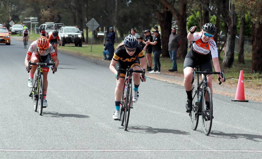 VICTORY: Illawarra's Sarah Cliff raises her fist after winning the under-17 girls road race. Picture: Les Smith