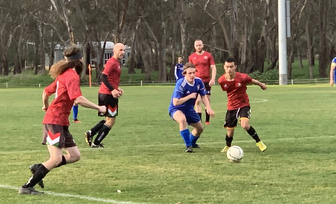 BACK IN ACTION: Lake Albert and Albury FC players battle for possession during Sunday's trial. Picture: Jon Tuxworth