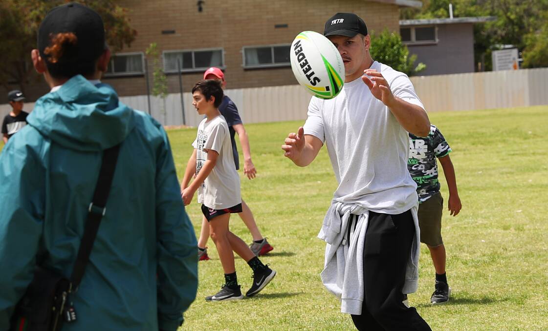 WAGGA VISIT: South Sydney centre James Roberts plays some football with the kids at Sunday's Yandarra Festival. Picture: Emma Hillier