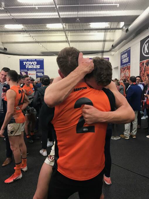 RELIEF: Jacob Hopper hugs older brother Zac in the GWS sheds after the Giants beat Collingwood in last week's preliminary final. 