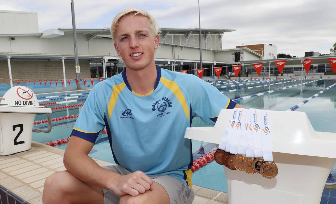 TALENT: Wagga swimmer Jamie Mooney with his medal haul from January's state age championships. He will contest the national championships this week. Picture: Les Smith