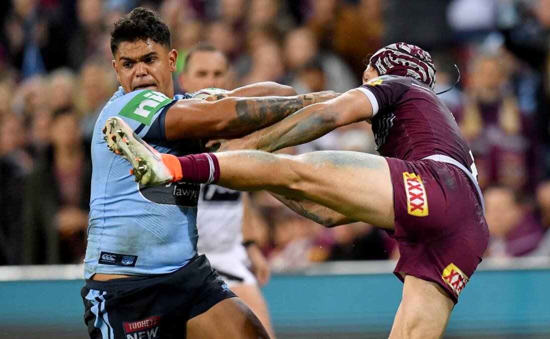 QUIET NIGHT: Latrell Mitchell fends off Kalyn Ponga. Picture: AAP Image/Darren England.