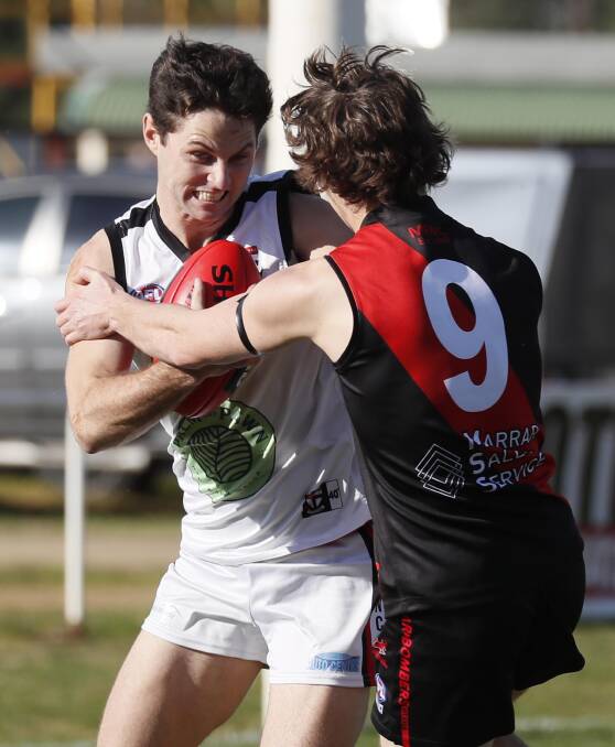 TUSSLE: North Wagga's Nathan Dennis tries to escape Marrar's Fletcher Jenkins. Picture: Les Smith