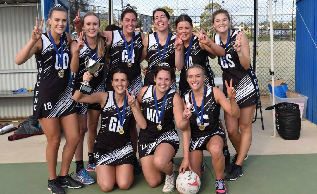 Sarah O'Leary (back lef)t and Emily O'Leary (front left) celebrate a first grade premiership with The Rock-Yerong Creek. 