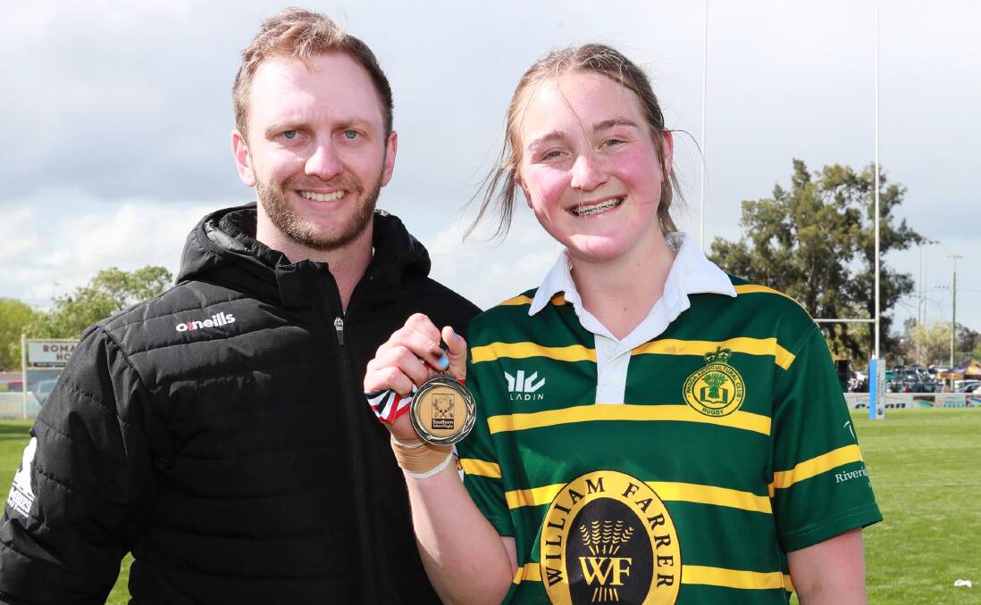 Player of the match Megan Seis with Tom Adamson, whose parents Tonia and David donated the medal. Picture: Les Smith