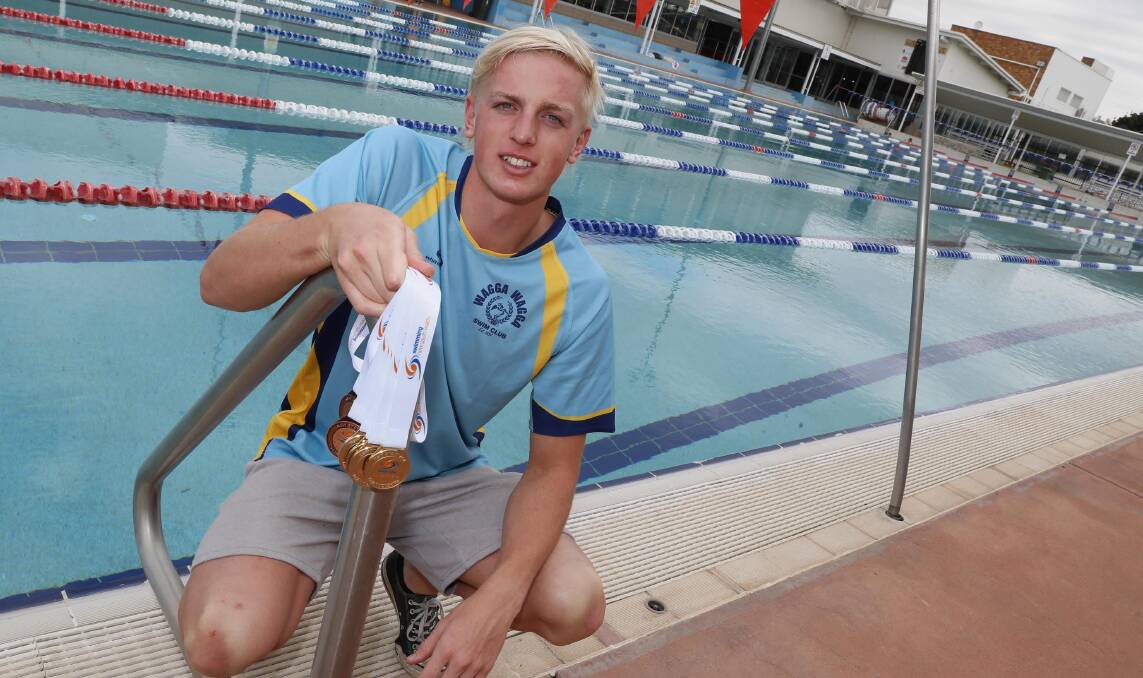 Jamie Mooney with his medals at Oasis Aquatic Centre on Thursday. Picture: Les Smith