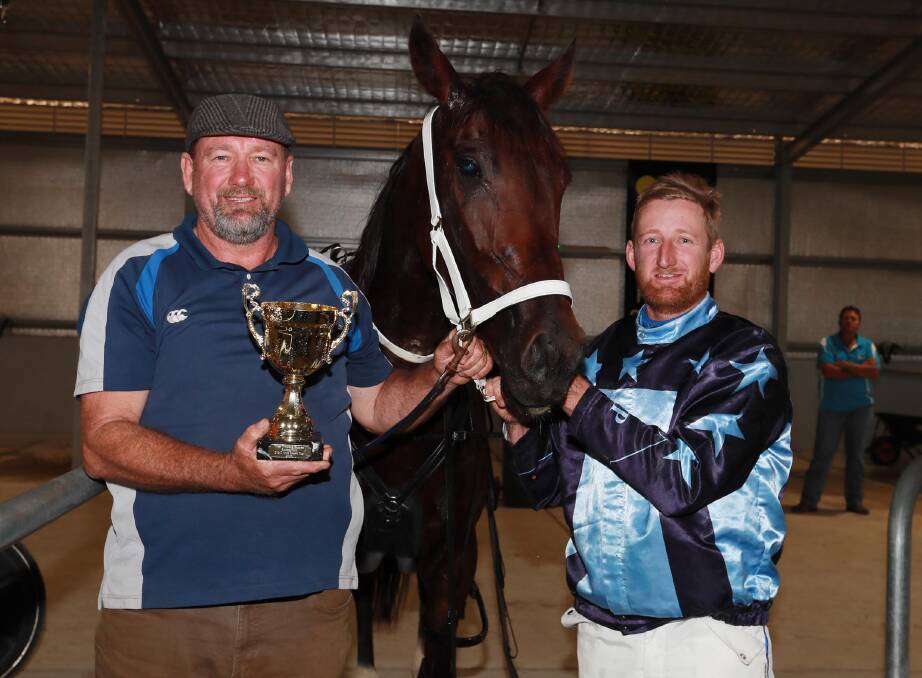 Trainer David Kennedy and driver Jackson Painting with the West Wyalong Cup after Whereyabinboppin's easy win. Picture: Les Smith 