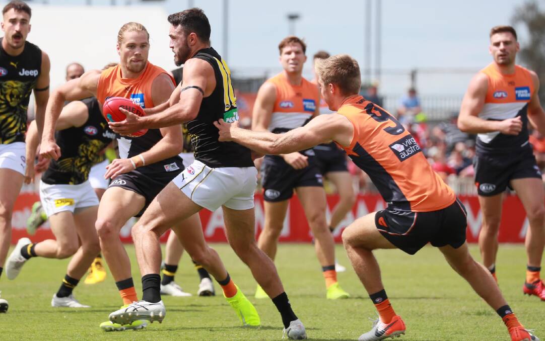 WAITING GAME: Greater Western Sydney's Harry Himmelberg (left) looks to put pressure on Richmond's Jackson Hately during the pre-season game at Wagga in March. Picture: Les Smith