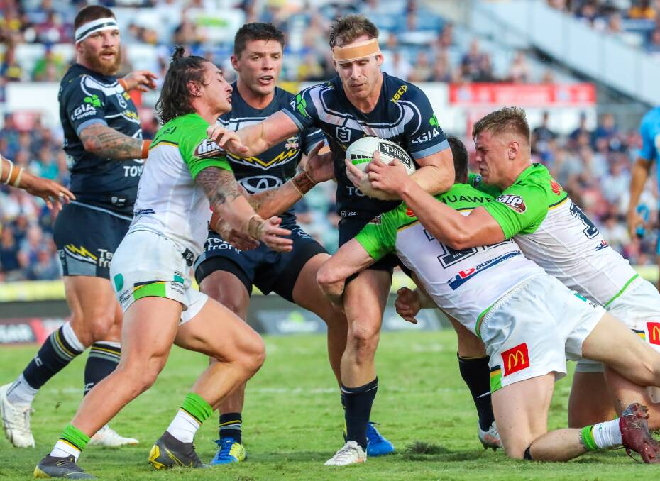 DEFENSIVE GRIT: Raiders fullback Charnze Nicoll-Klokstad muscles up in defence during Canberra's 30-12 win over North Queensland in Townsville on Saturday.