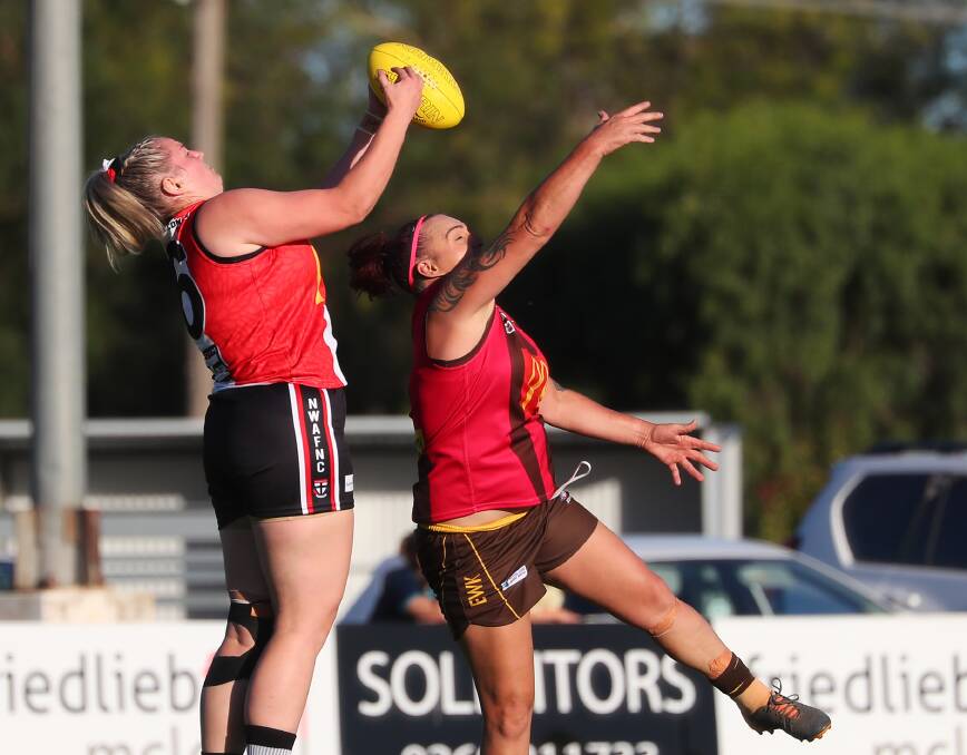 CRUNCH TIME: North Wagga's Skye Davey takes a mark over East Wagga-Kooringal's Holly Conroy during a match earlier this season. Picture: Emma Hillier
