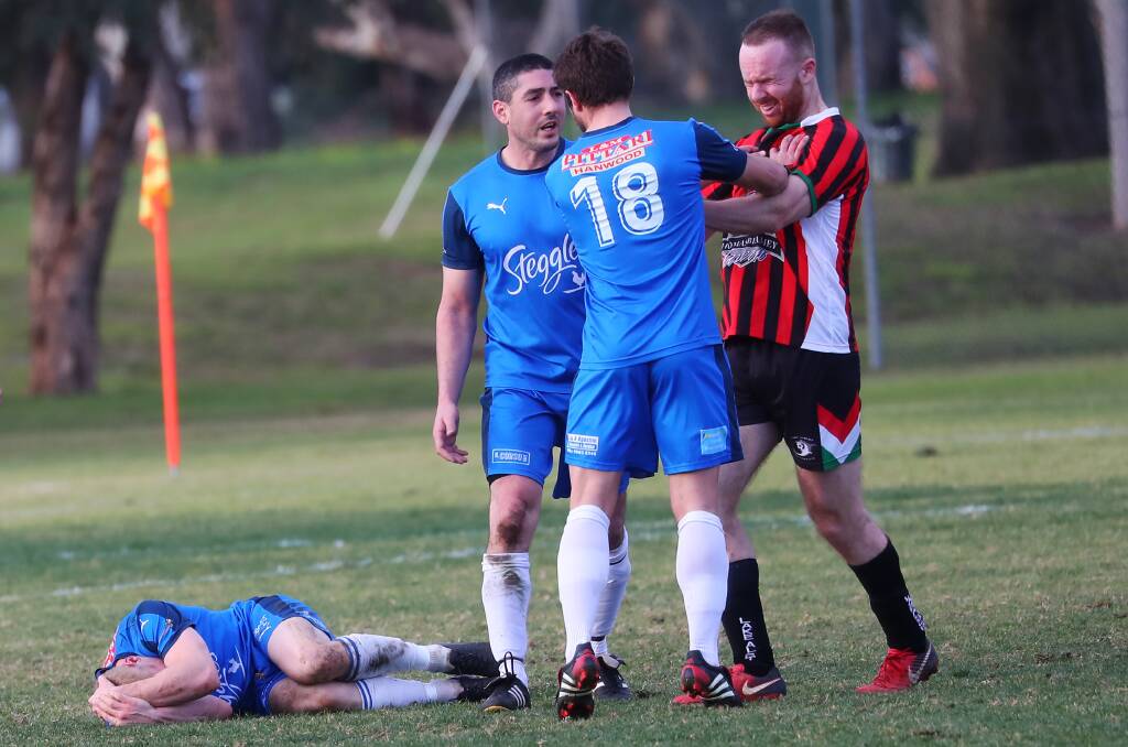 PHYSICAL GAME: Hanwood players remonstrate with a Lake Albert opponent as a teammate lies on the ground. Picture: Emma Hillier. 