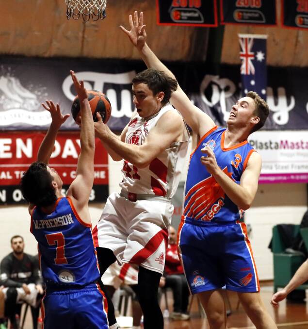 TOUGH LOSS: Wagga Heat's Cameron McPherson and Eddie Merkel try to shut down a George White drive during Saturday's loss to St George White. Picture: Les Smith