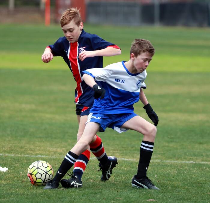 JUNIORS RETURN: Tolland's Harrison Conroy and Henwood Park's Felix McIntyre compete for the ball during a round one under-13s match last weekend. Picture: Les Smith