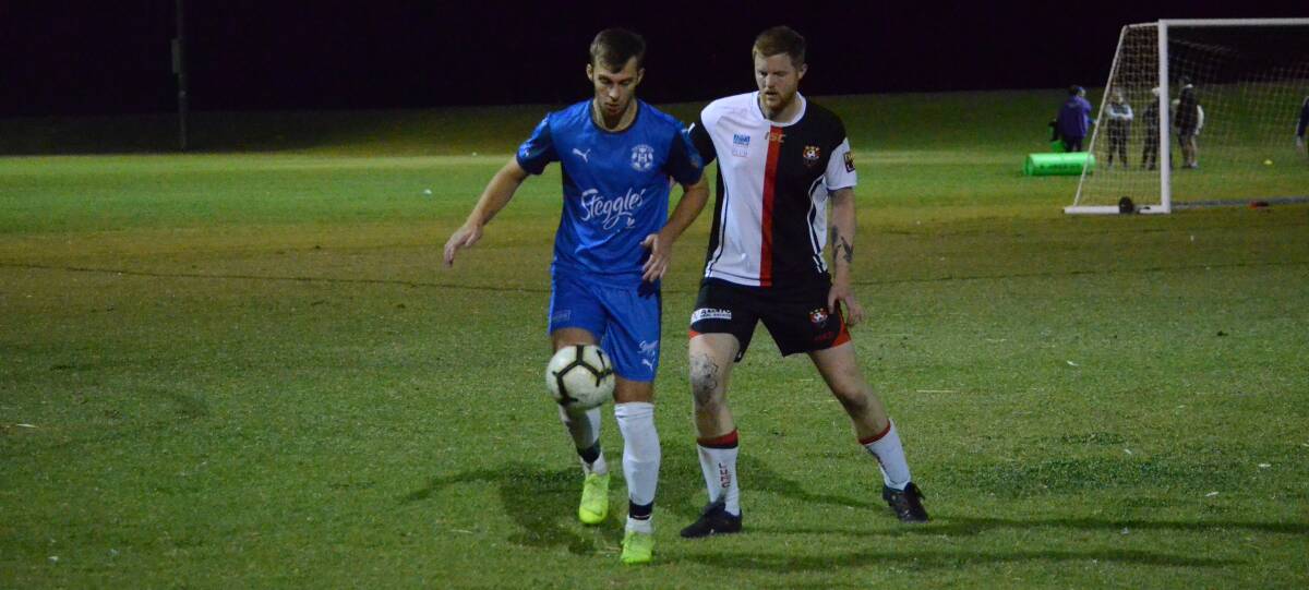 ANOTHER WIN: Hanwood's Nick Kennedy looks to shield the ball away from Leeton's Ethan Murphy. Picture: Liam Warren. 
