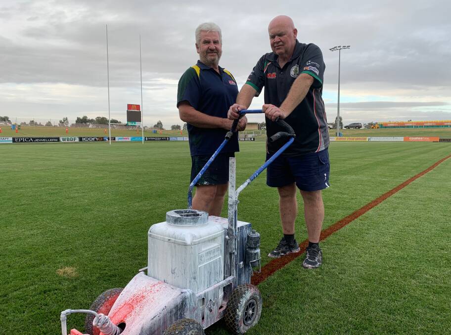 HARD SLOG: Wagga Rugby League chairman Warren Barclay and Group Nine secretary Bob Hay get the field's lines ready on Thursday. 