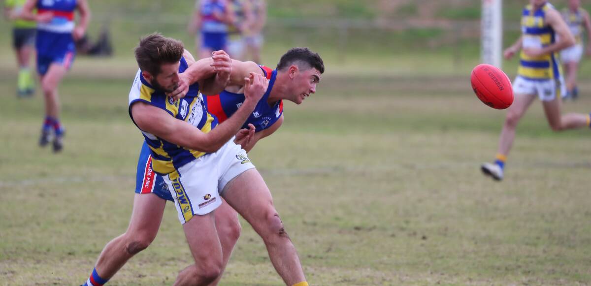 DOGS BARKING: MCUE's George Kendall and Turvey Park's Rhett Weidemann jostle during the Bulldogs' upset win at Maher Oval last week. Picture: Emma Hillier