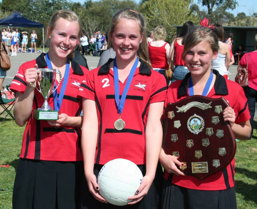 MILESTONE: Marrar stalwart Tara Taylor with triplet sisters Deanna and Emma after the Bombers' junior grand final win in 2009. Picture: Marrar Bombers 