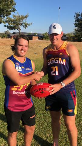 RECRUIT: Kai Watts (left) is welcome to Ganmain-Grong Grong-Matong by fellow forward Riley Corbett. Picture: GGGM