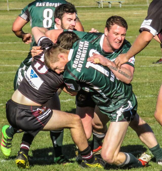 BACK PLAYING: Tumbarumba Greens players Quinn Rooney and Steven Arnold tackle a Charles Sturt University opponent during a game this season. Picture: Wendy Lavis