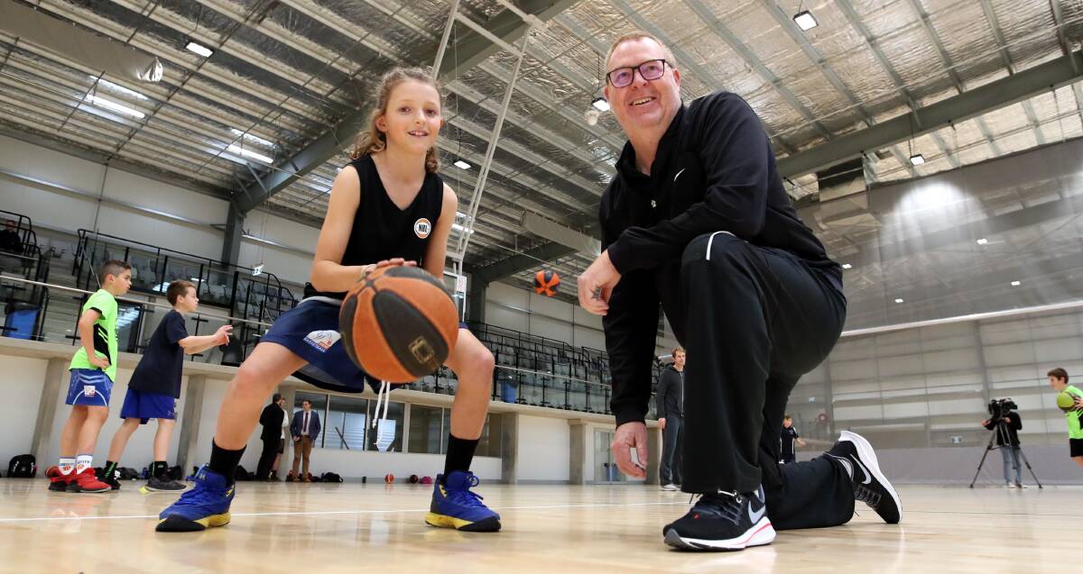 HANDY TIPS: Former NBL head coach Rob Beveridge passes on some advice to Tumut's Matt Delaney, ten, at a coaching clinic at Wagga on Wednesday. Picture: Les Smith