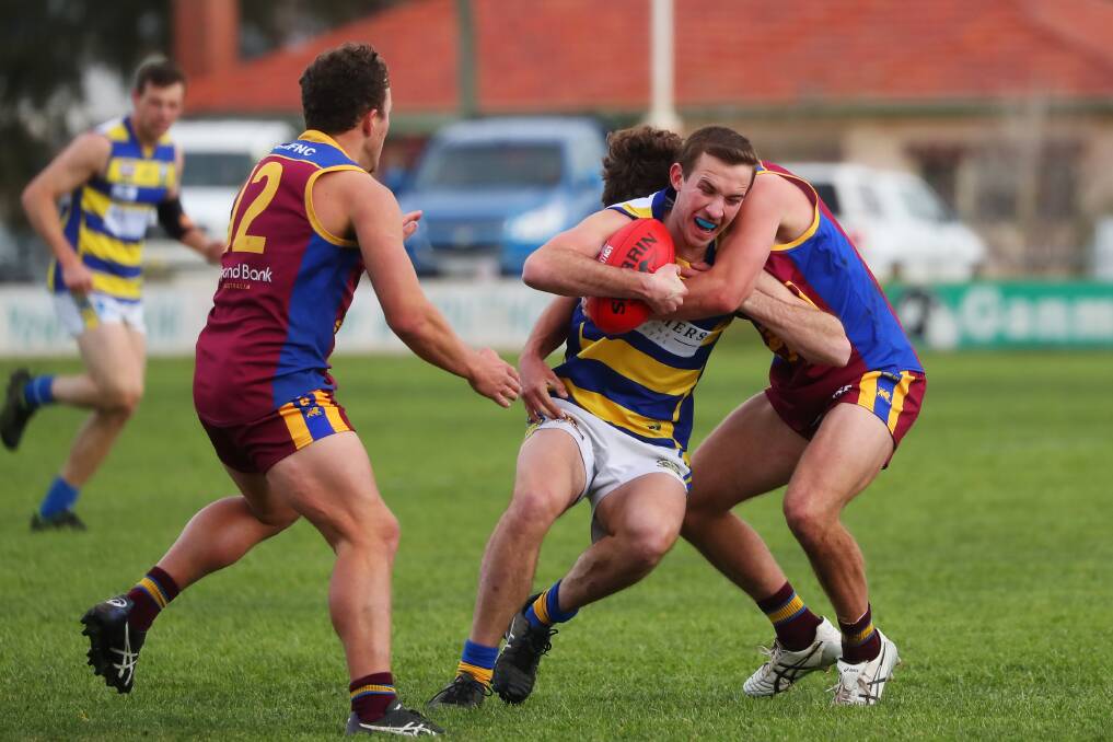 NEED A LIFT: MCUE's Jack Garey tries to break a tackle during last month's clash with GGGM. Picture: Emma Hillier
