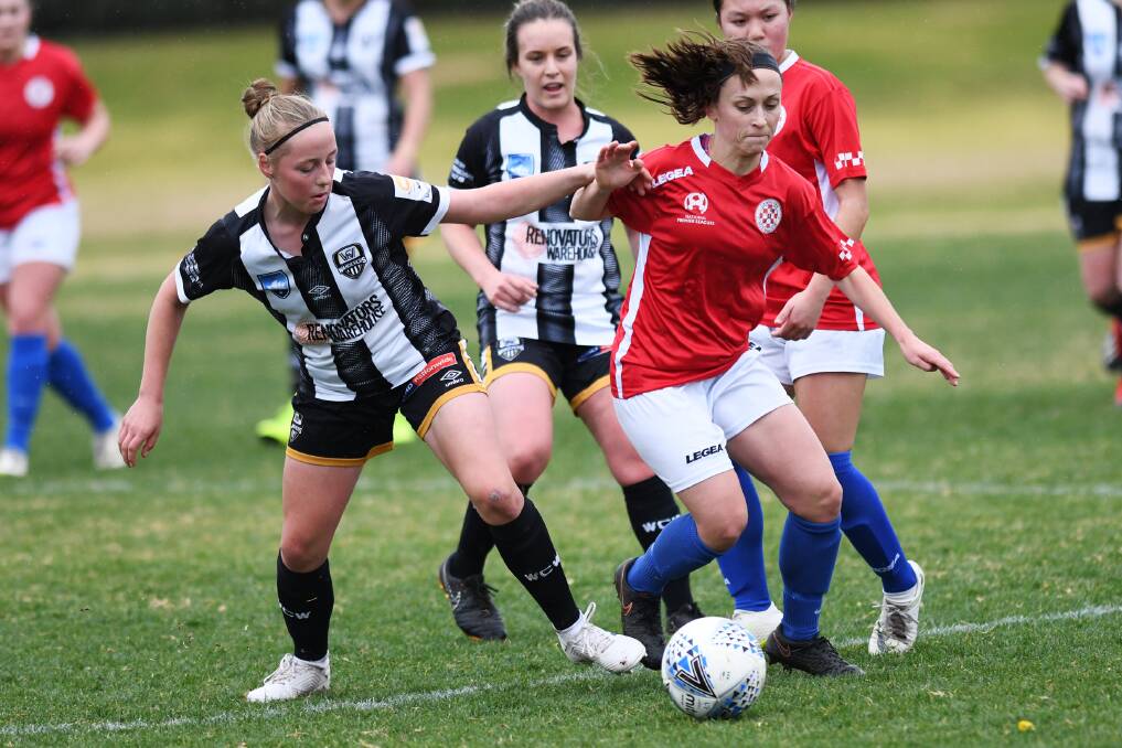READY FOR TITLES: Wagga City's Megan Castle (left) and Canberra FC's Krista Hagen do battle at Gissing Oval on Sunday. 