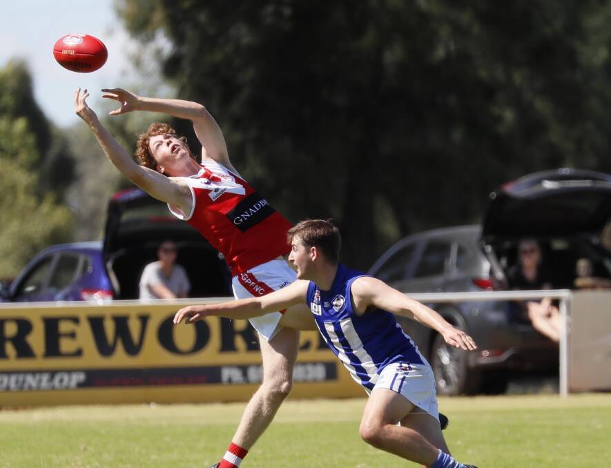 HIGH FLYER: Collingullie-Glenfield Park's Noah Harper takes a mark over Temora's Angus McRae in Saturday's trial match. Picture: Les Smith