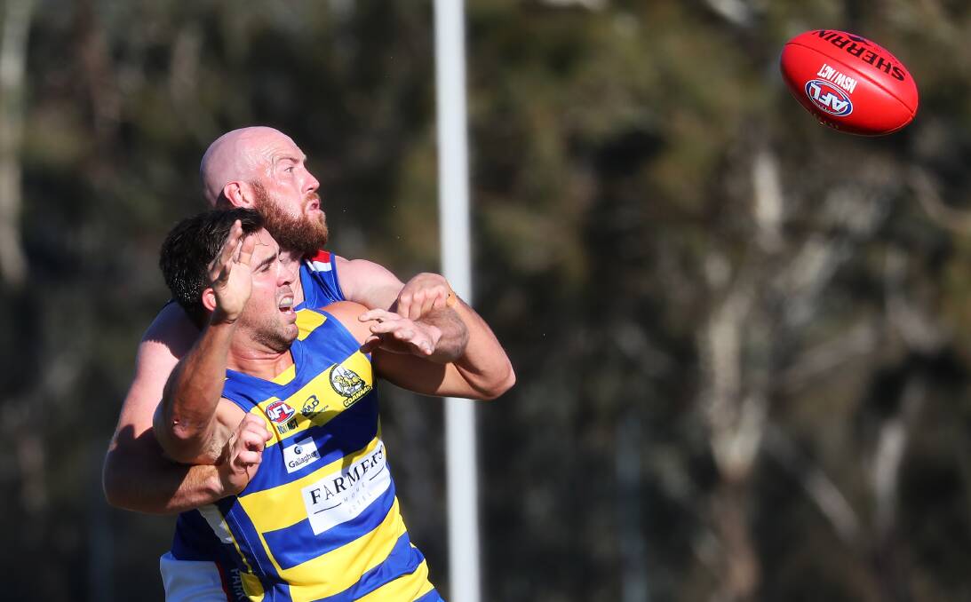 EYES ON PRIZE: MCUE ruckman Sam De Sousa and Turvey Park opposite Shaun Allan go up in a marking contest on Saturday. Picture: Emma Hillier