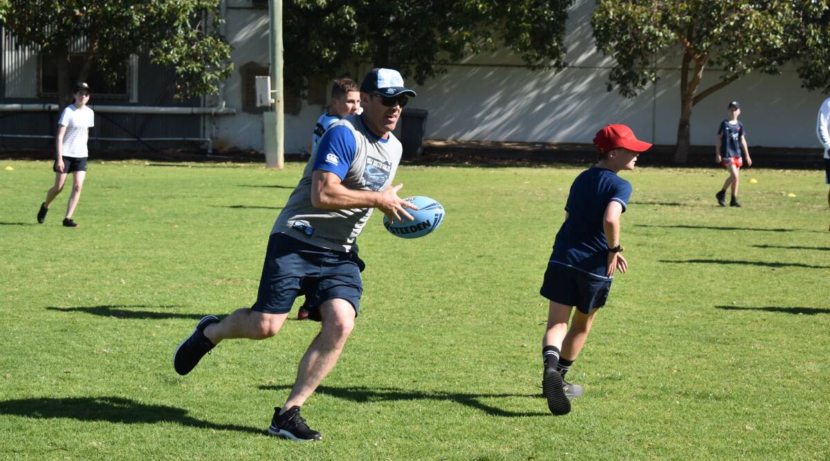 CLINIC: Fittler playing a game of touch football during a visit to Griffith on Monday. Picture: Liam Warren