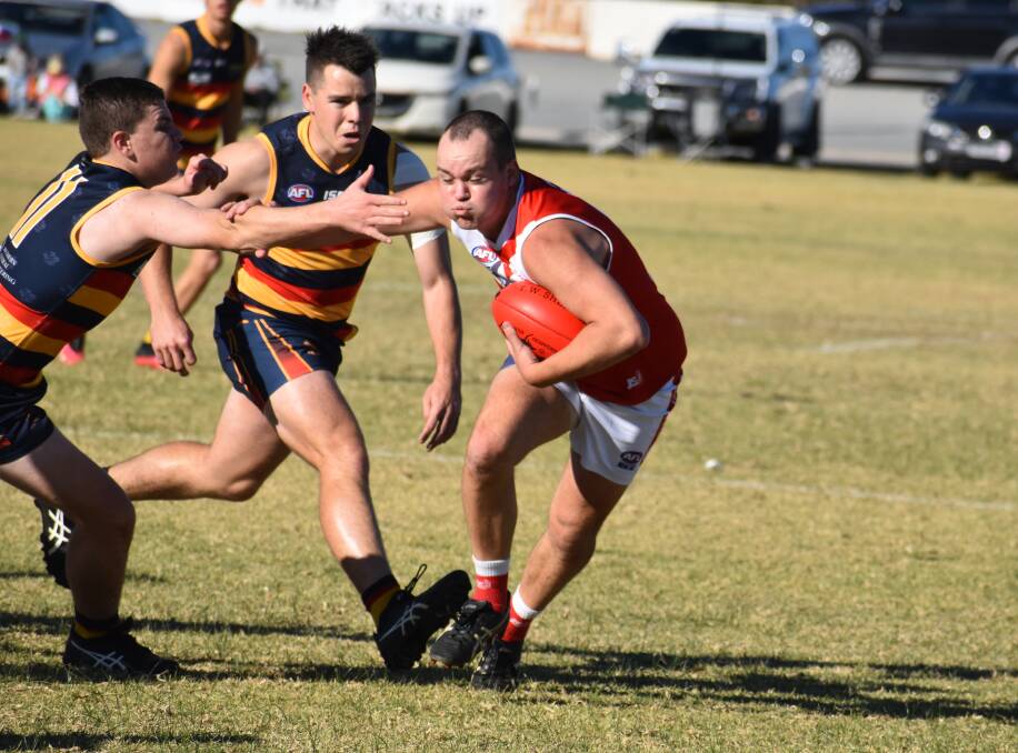 GOOD WIN: Collingullie-Glenfield Park's Spencer Small tries to palm off a Leeton-Whitton opponent during Saturday's win at Leeton Showground. Picture: Liam Warren