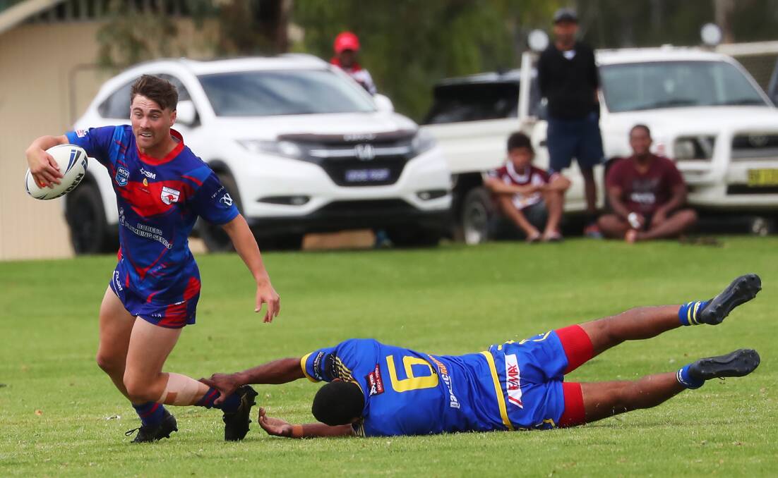 NEW ERA: Kangaroo Eddie Jackson slips through a Junee tackle during the Junee Nines tournament earlier this month. Picture: Emma Hillier