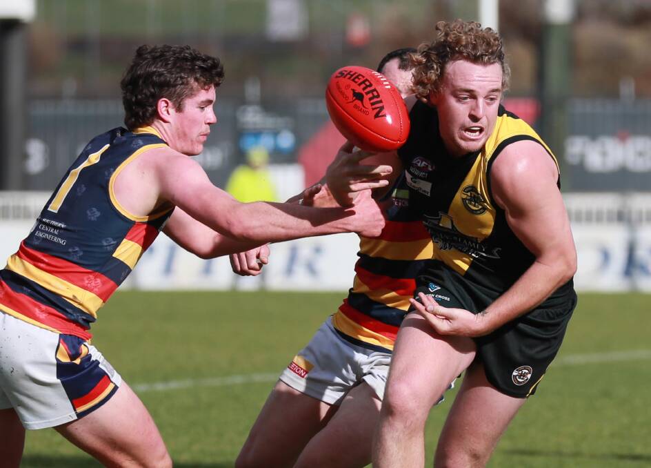 OUT OF JAIL: Wagga Tigers Brendan Myers is tackled by Leeton-Whitton's Nathan Ryan at Robertson Oval on Saturday. Picture: Les Smith