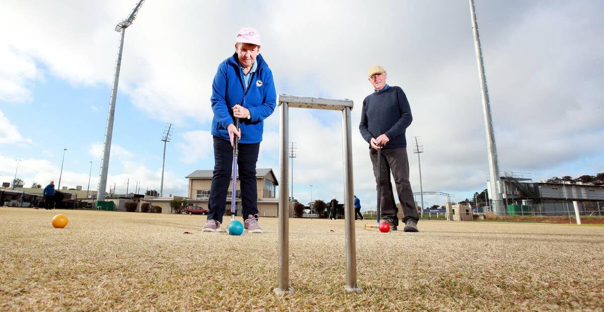 CROQUET'S BACK: Dorothy Munro and David Glastonbury get in a game on the lawns of Wagga Croquet Club on Wednesday. Picture: Les Smith