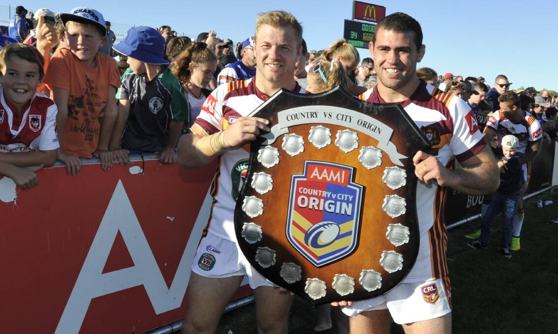 BIG STAGE: Ryan Hinchcliffe and Dale Finucane hold the shield aloft after Country Origin's win over City Origin at Wagga in 2015. Picture: Les Smith